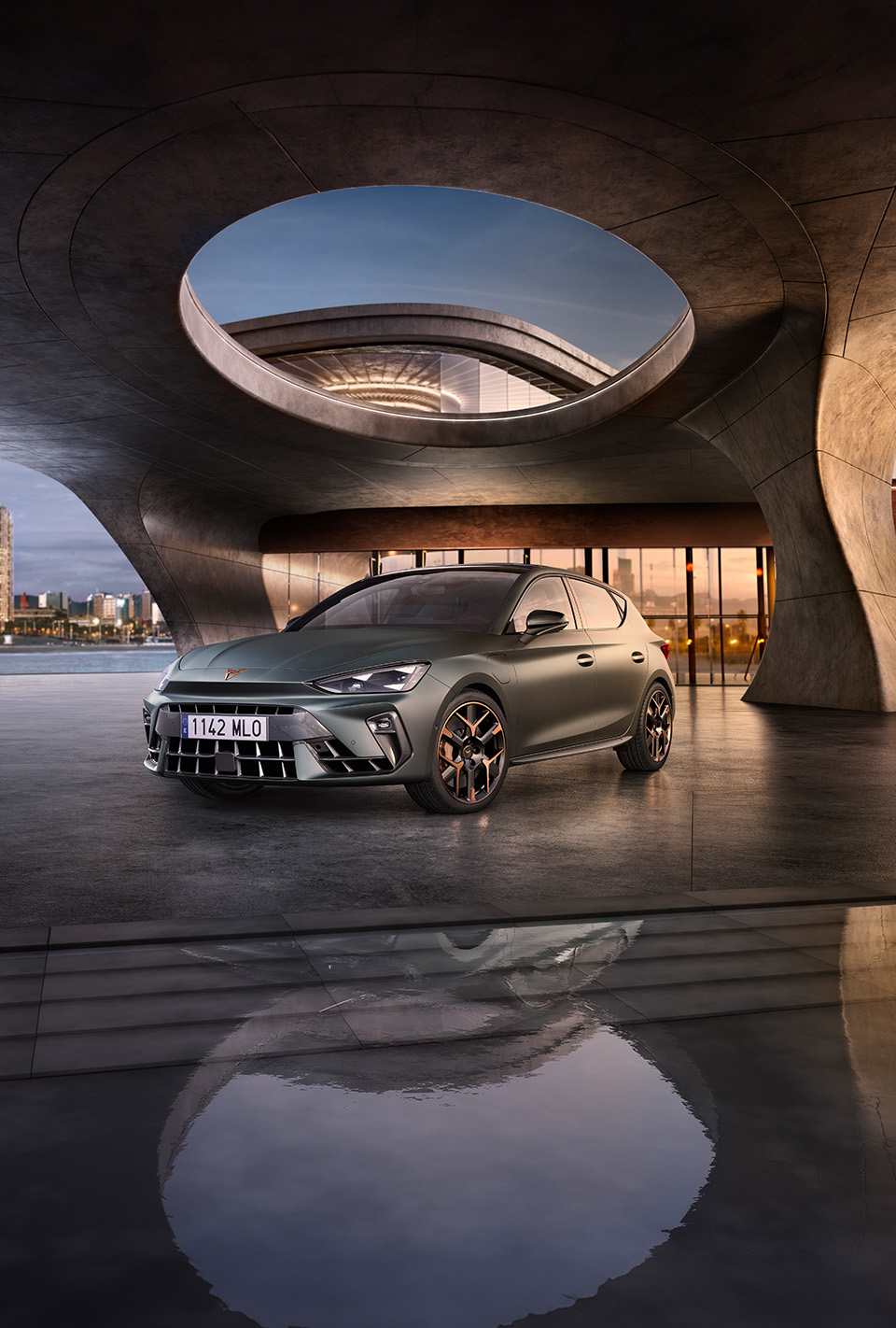 The 2024 Century bronze matte CUPRA Formentor parked on a reflective waterfront promenade. The sporty and aerodynamic new vehicle is positioned centre frame. The setting features futuristic architecture and Barcelona’s glowing city skyline at dusk.